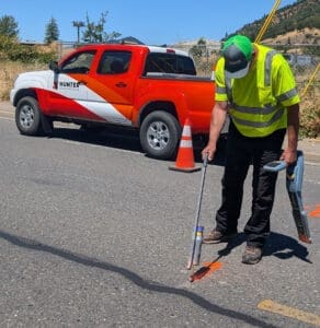 Allen Realini, OSP Inspector at Hunter Communications marks the pavement for safe digging.