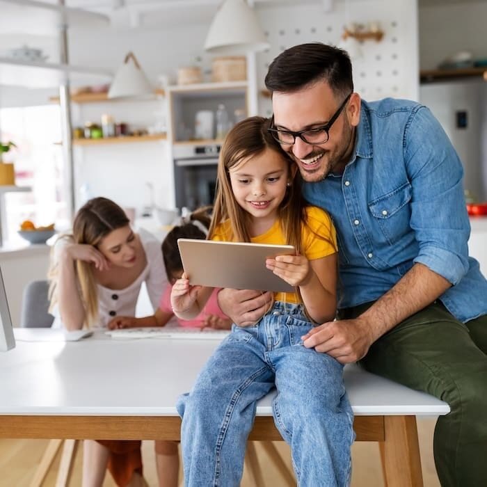 Online school, technology, family concept. Happy parents helping to children to study at home Online school, technology, family concept. Happy young parents helping to children to study at home